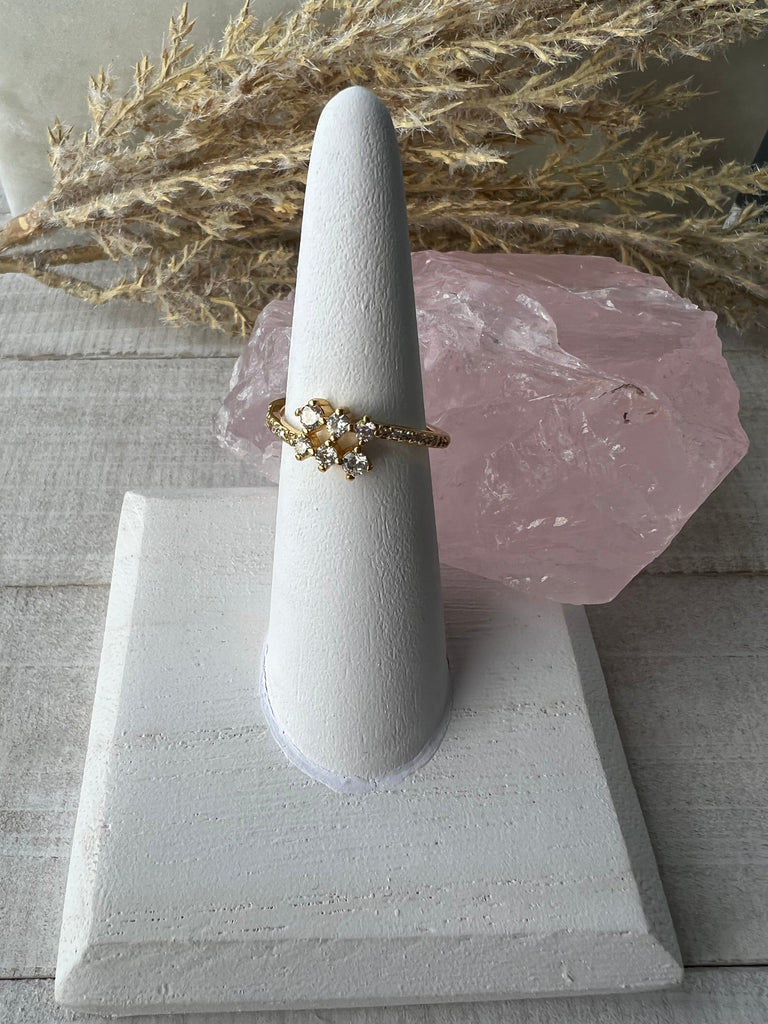 14k gold dainty adjustable ring with cubic zirconia clusters on top and micro pave accents on the side